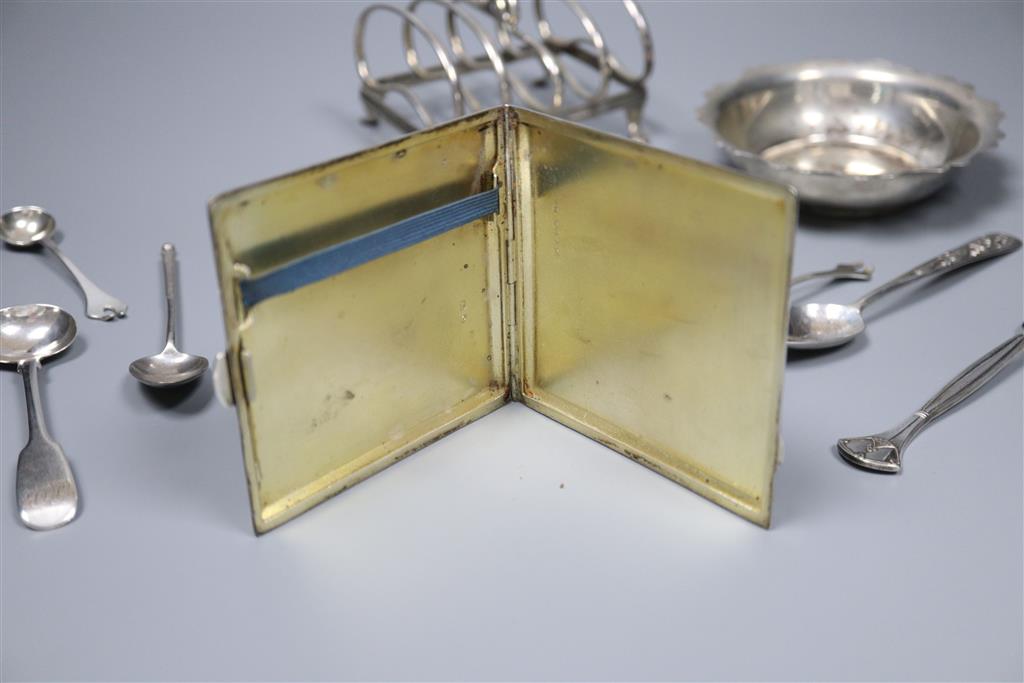 An early 20th century silver toastrack, a silver bowl, silver cigarette case and minor flatware including silver and plated.